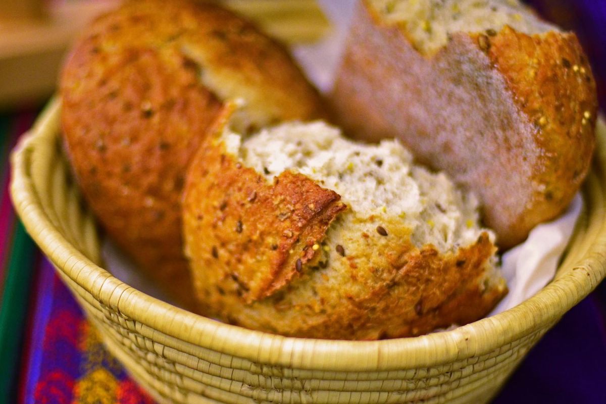 a loaf of bread broken in pieces, in a basket